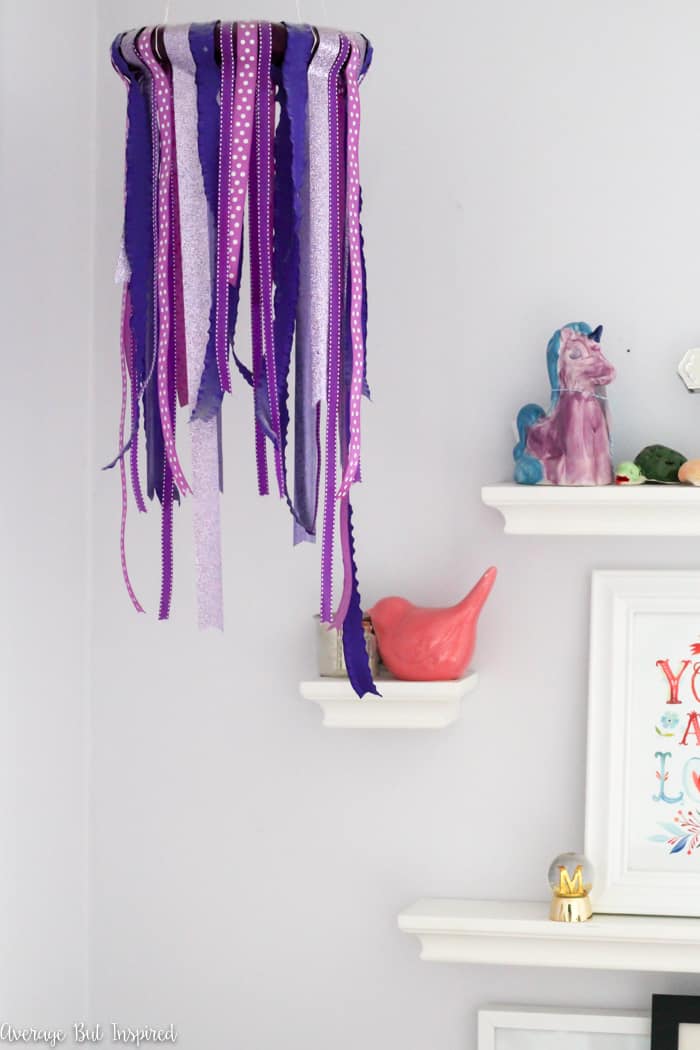 A DIY ribbon chandelier is an easy way to add a fun decorative touch to any room - especially a kids bedroom! This DIY decor project only requires four supplies to make! So easy. #diyhomedecor #homedecorcrafts #ribbonchandelier