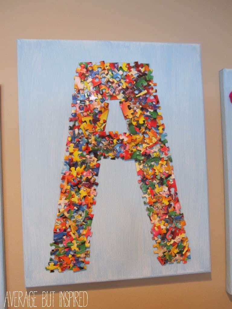 Make your own kids playroom art with fun supplies like puzzle pieces!