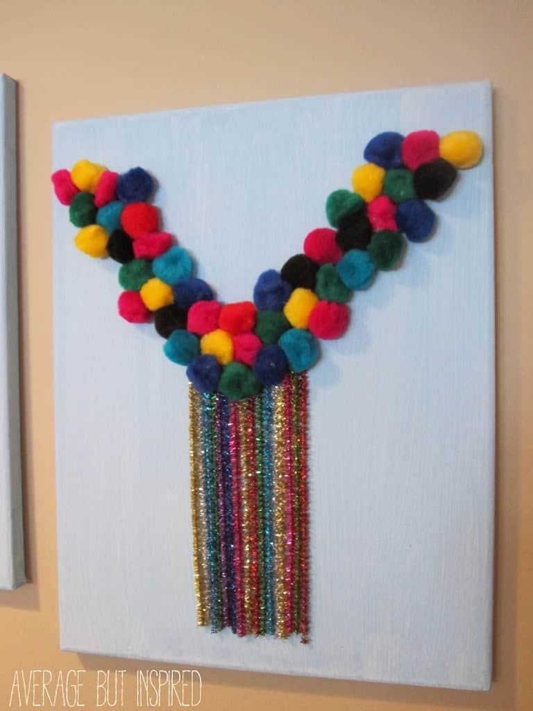 Make your own DIY wall art for the playroom with fun supplies like pom poms and pipe cleaners!