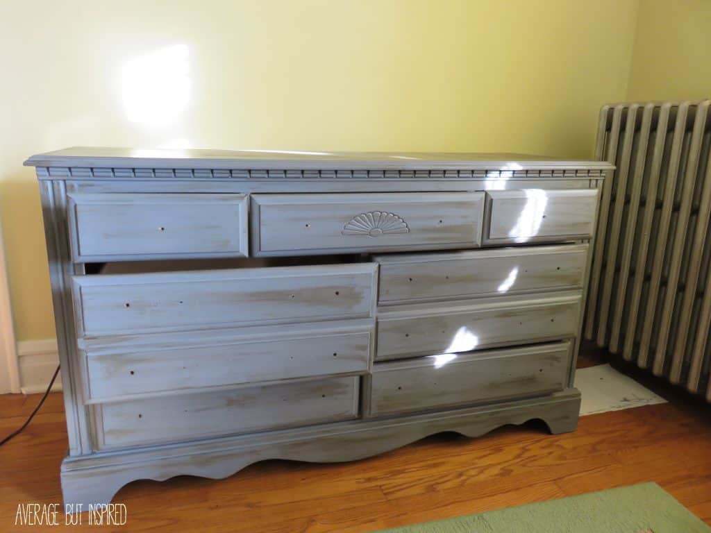 During this chalk painted dresser makeover, she put too much brown wax on the drawers. She removed the extra brown wax with clear wax.