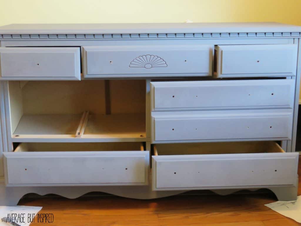 The first coat of gray chalk paint on this dresser makeover looks lighter than it turned out when finished.