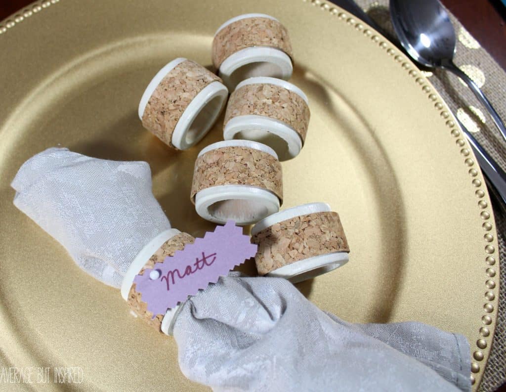 DIY cork napkin ring place cards pull double duty by keeping napkins in place and telling guests where to sit! Learn how to make them with this quick and easy tutorial.