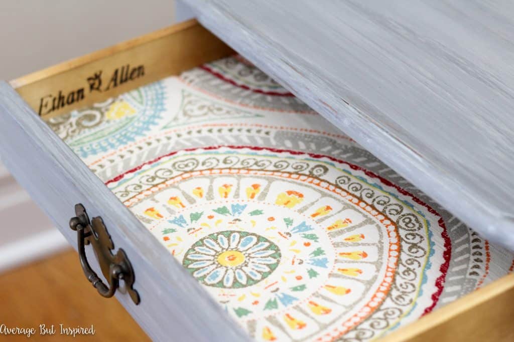 A placemat is used to line a drawer.