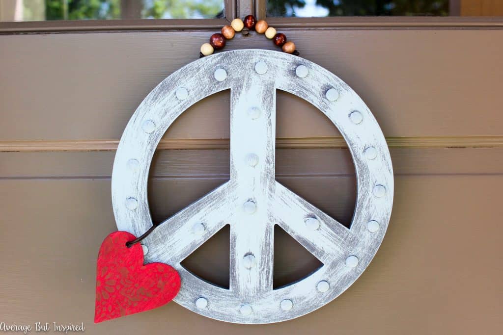 A DIY Peace Sign Wreath is a great way to greet visitors to your home! Get the full tutorial in this post.