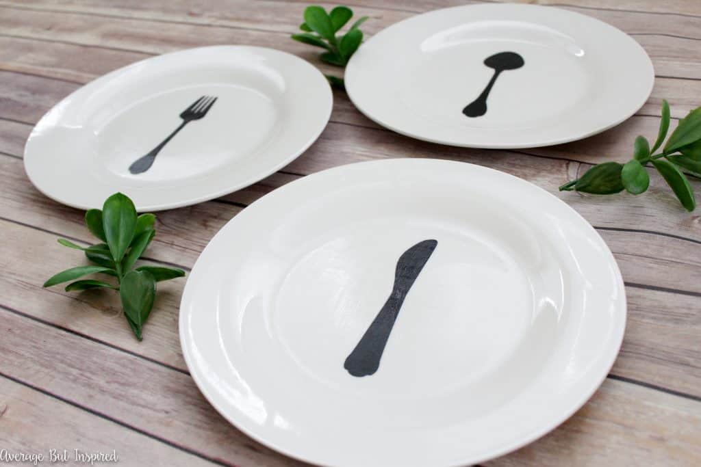 Customize plain plates from the dollar store with a fork, knife, and spoon silhouette to create adorable plate art for your home! Mod Podge seals the diy plate decor and keeps the designs looking good!