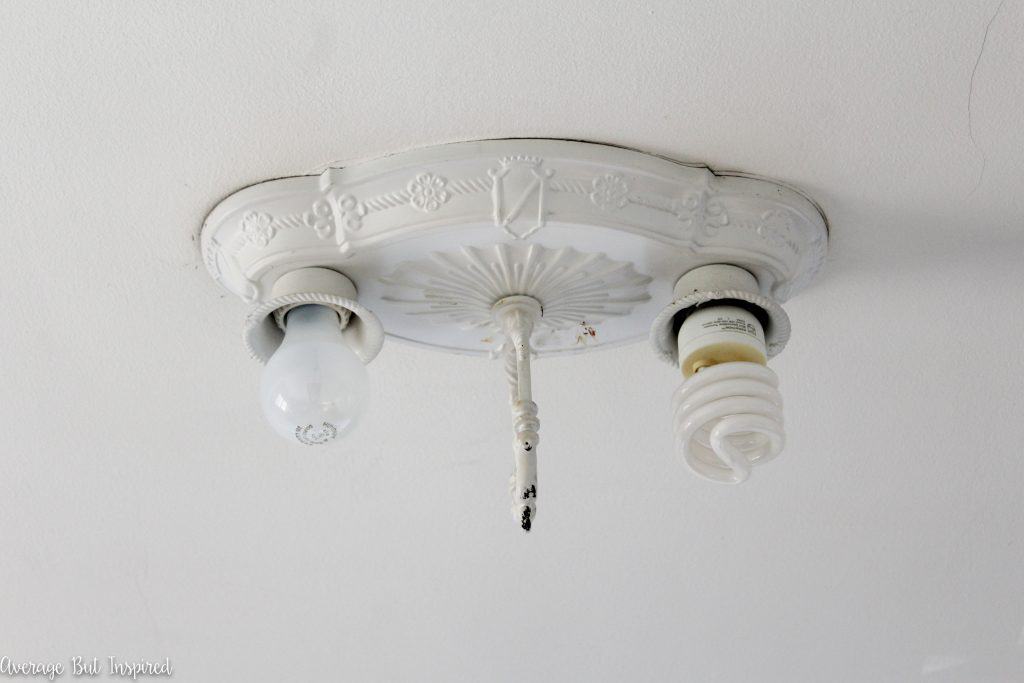 This 1920's light fixture had been given a terrible spray paint makeover at some point in its life. See the gorgeous after photos in this post!