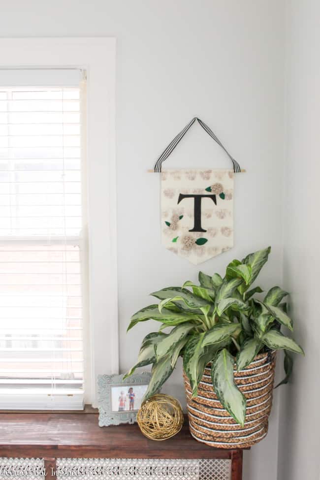 This tutorial teaches you how to make a trendy felt and canvas banner with a monogram! It's easy to make this cute home decor that you can use for your door or any wall!