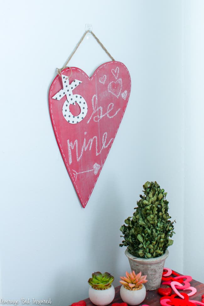 Turn an unfinished wood heart into an adorable DIY Valentine's Day Chalkboard for a sweet addition to your Valentine's Day decor! This is an easy Valentine's Day craft idea that anybody can make!