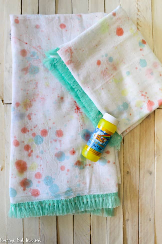 Turn your kids' bubble solution into bubble paint and make these adorable bubble paint tea towels for your kitchen! Bubble paint tea towels are easy to make and a great project to have the kids help with!