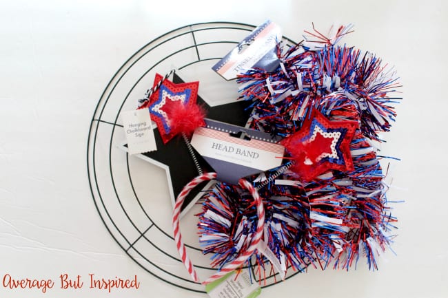 Make a DIY Fourth of July Wreath with supplies from Dollar Tree! This wreath cost $5 total to make! The tinsel garland adds a festive and sparkly touch for the Fourth of July.