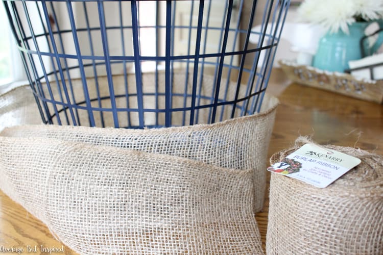 It's easy to transform a dollar store laundry basket into a pretty burlap basket! What a great burlap craft project!