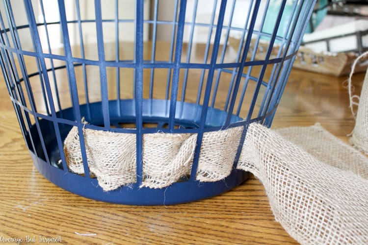 It's easy to transform a dollar store laundry basket into a pretty burlap basket! What a great Dollar Tree craft project!