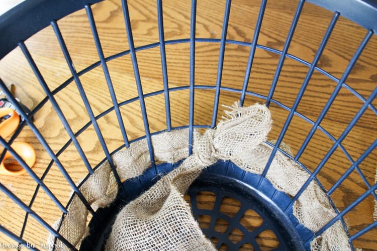 It's easy to transform a dollar store laundry basket into a pretty burlap basket! What a great Dollar Tree craft project!