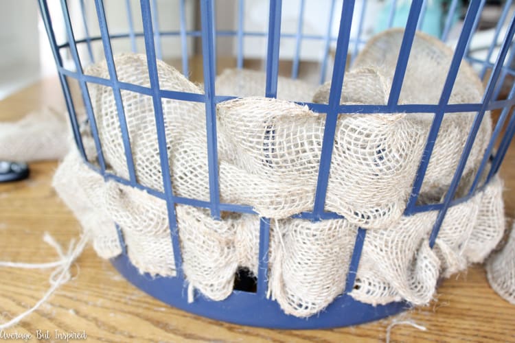 It's easy to transform a dollar store laundry basket into a pretty burlap basket! What a great burlap craft.