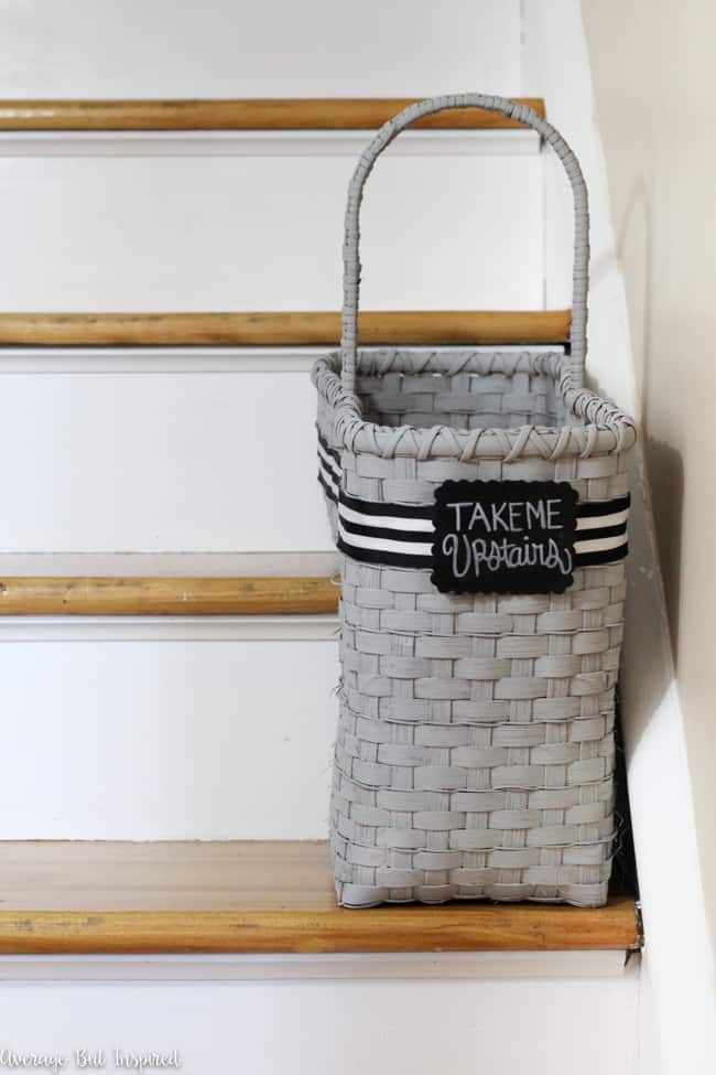 A dated staircase basket from the thrift store got a fresh new look with spray paint, ribbon, and a chalkboard tag.