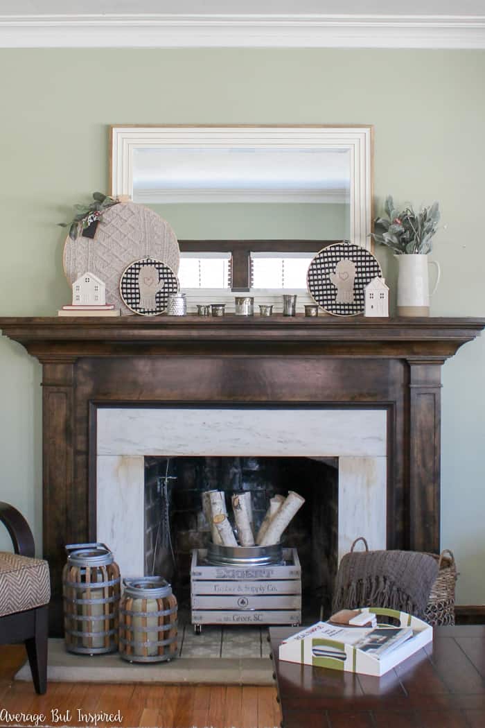 Looking for budget-friendly cozy winter mantel decorating ideas? Look no further! This winter mantel decor uses inexpensive and thrifted items to create a look that's perfect for the winter season! #wintermantel #wintermantle #manteldecor