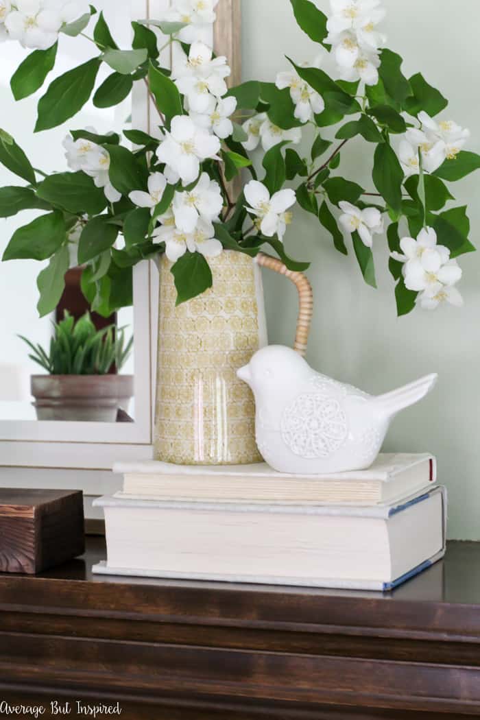 Update your living room with a simple summer mantel and decor updates. See how this blogger freshened her home for summer with inexpensive items and fresh greenery.