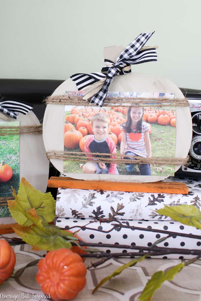 So cute! Transform Dollar Tree pumpkin decorations into adorable pumpkin picture frames that are perfect for displaying fall photos! #dollartree #dollartreecrafts #dollartreedecor #fallcrafts