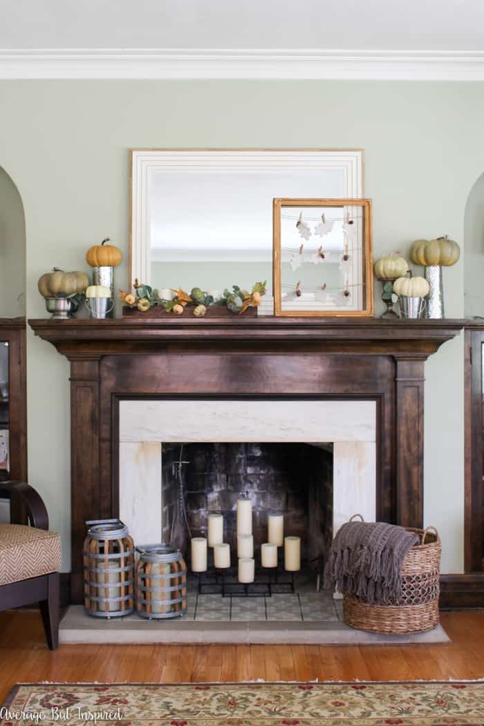Beautiful! See how this blogger used inexpensive items like faux pumpkins, book pages, and acorns to create a pretty fall mantel in shades of green, orange, and white.