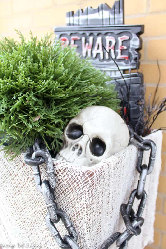 Fill an outdoor planter with dollar store Halloween decorations for a spooky outdoor Halloween display! This post has lots of good dollar store Halloween decor ideas!