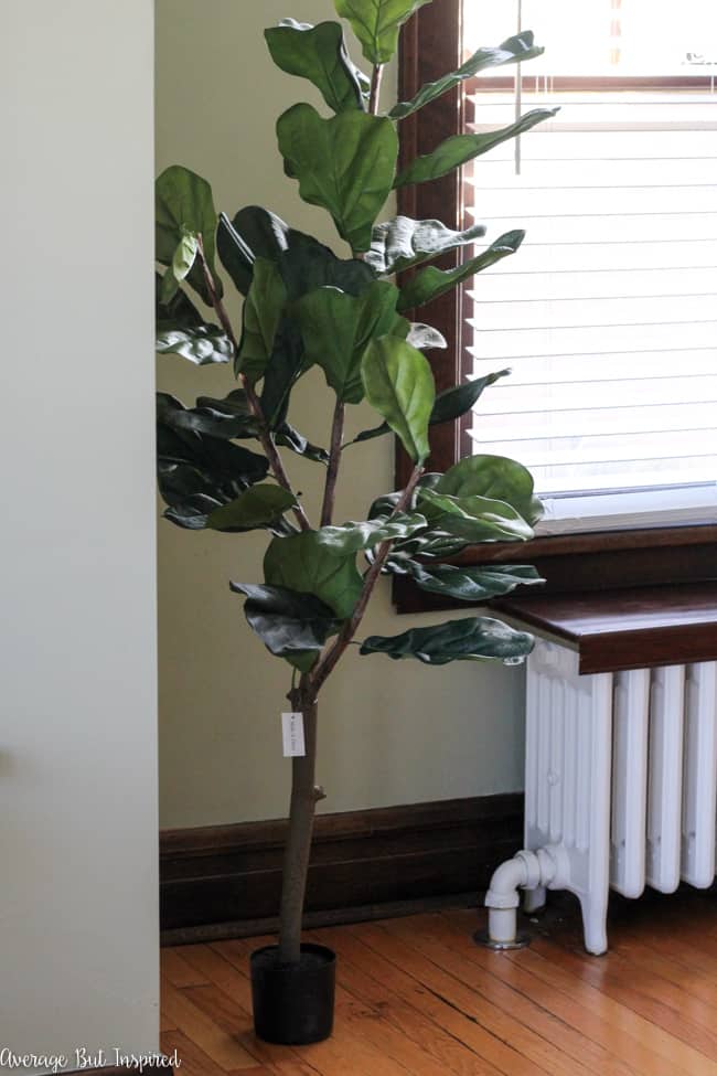 This fake fiddle leaf fig tree looks much more realistic with the addition of some dollar store supplies. Read this post to see how to make a fake fiddle leaf fig tree look real.