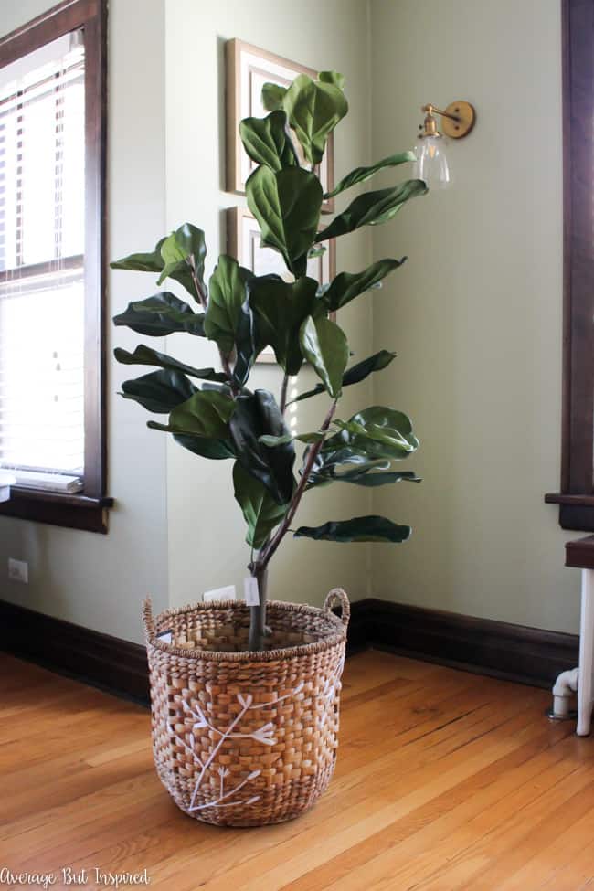 A gorgeous embroidered basket is one item that helps make this fake fiddle leaf fig tree look real. 