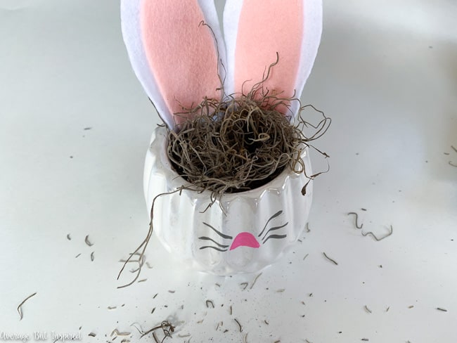 Fill the DIY Bunny Planter with craft moss prior to adding the faux succulent.