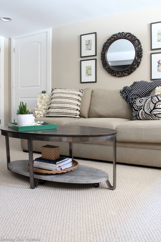 This oval coffee table with wood, metal, and concrete finishes is a perfect transitional style coffee table. Plus, hidden casters make it easy to move!