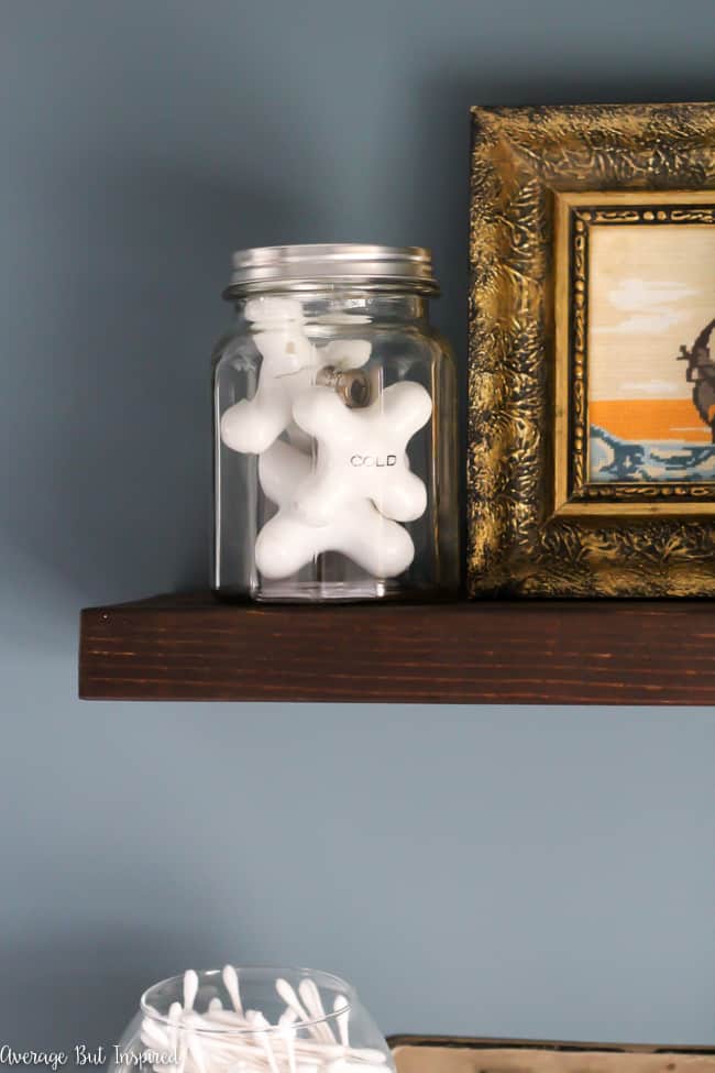 The original bath tub faucet handles were saved in this bathroom renovation and put on display to add some authenticity to the bathroom.