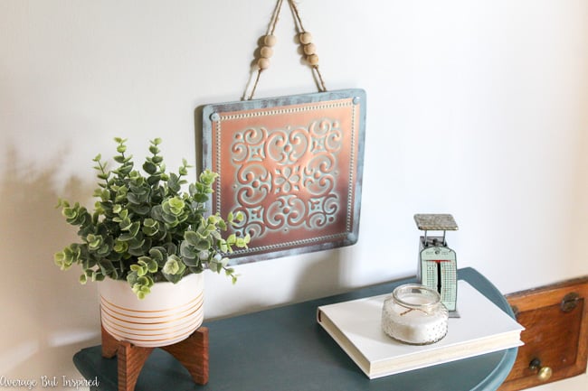 Create pretty tin tile wall art with supplies from the dollar store. You won't believe how easy it is!