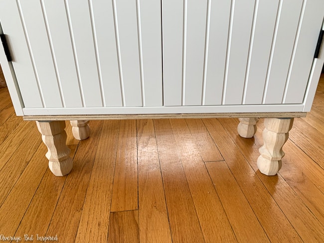 Add turned wood legs to the IKEA Silveran sink cabinet for a custom look.