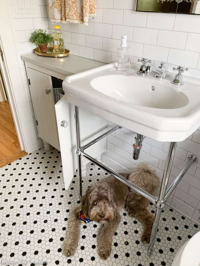 The IKEA Silveran sink cabinet is customized with a quartz countertop and wooden legs. It is the perfect small bathroom storage vanity!