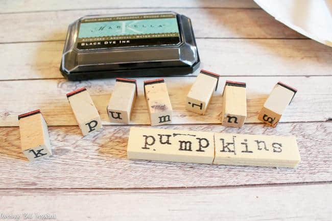 Use stamps on Dollar Tree Jenga pieces to create a cute pumpkin sign for fall.