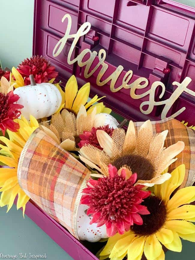 This is so pretty! Learn how to upcycle a toolbox into a planter! This fall arrangement is gorgeous and made entirely with Dollar Tree florals.