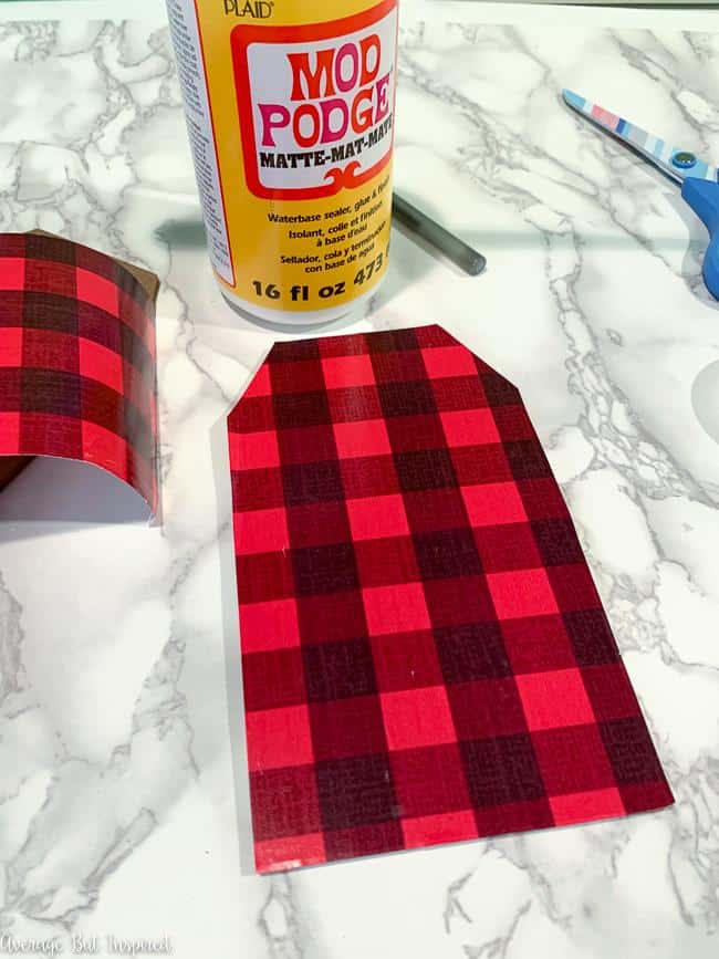 Buffalo plaid wrapping paper adds a festive touch to this Christmas craft.