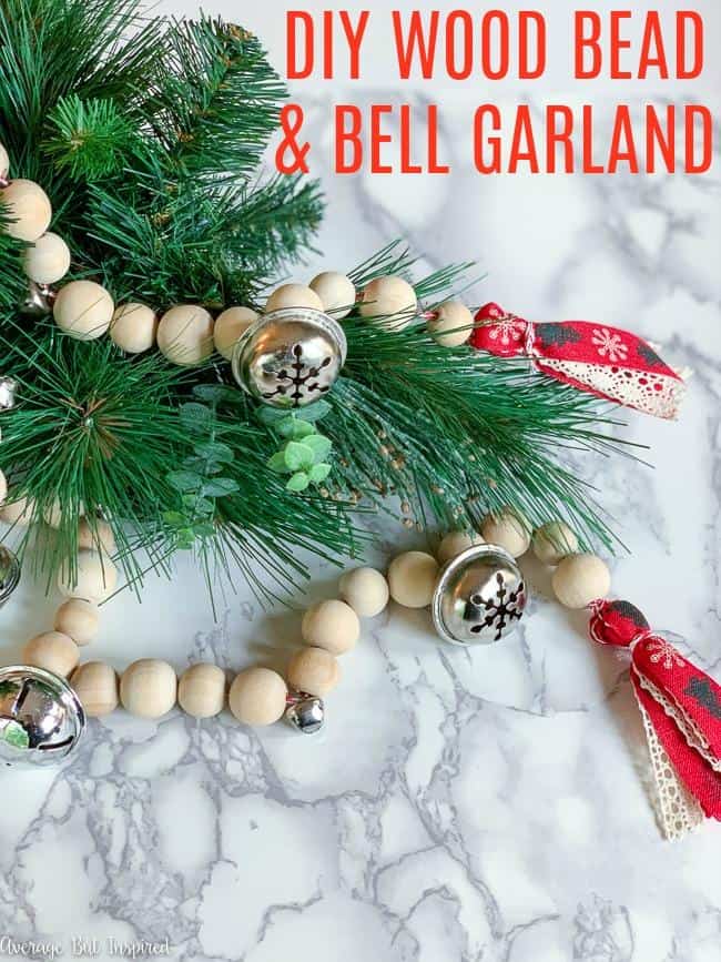 LOVE this DIY Christmas decor! Learn how to make a jingle bell wood bead garland to add a homemade touch to your Christmas decor this year. This easy Christmas craft is a pretty way to use simple supplies for a stunning decorative touch.