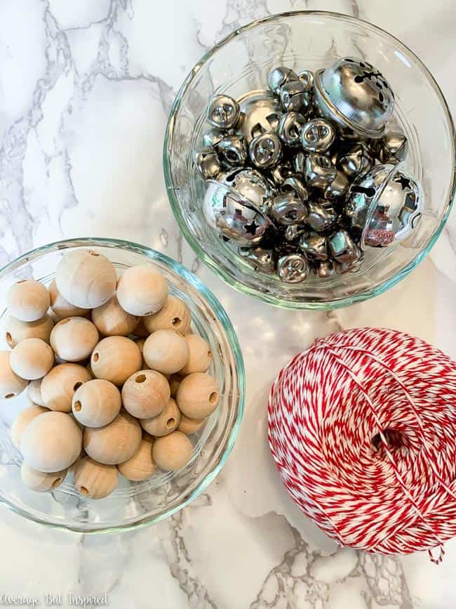 With these simple supplies - jingle bells, wood beads, and bakers twine - you can make a gorgeous Christmas garland!