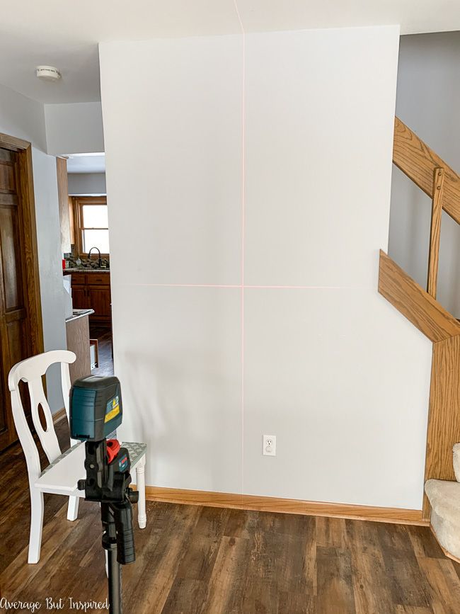 Learn how to paint a grid accent wall in this post. The laser level is very helpful when painting a DIY accent wall.