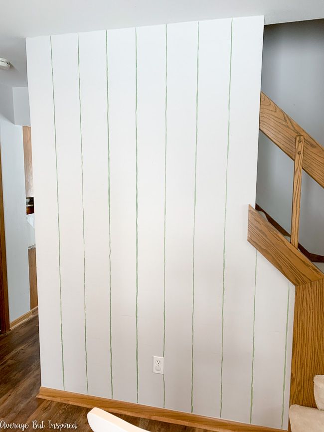 To paint a grid accent wall, go over the vertical lines with craft paint first.