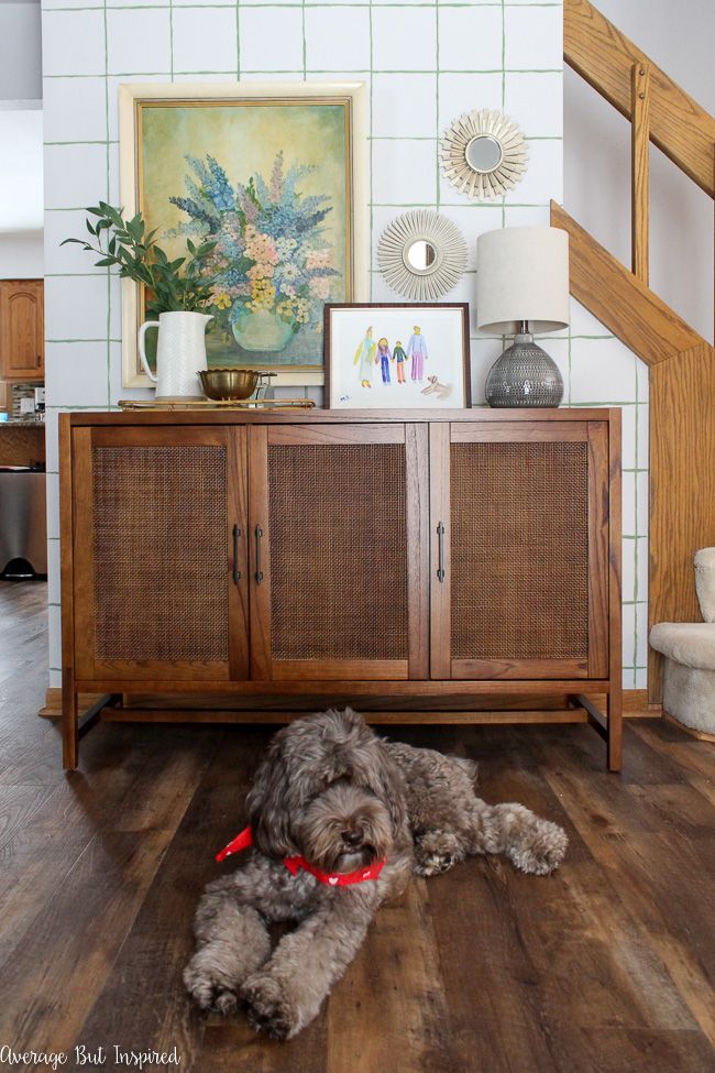 This DIY accent wall with a hand-painted grid pattern and the cane console or rattan console make for a beautiful statement when entering this home.