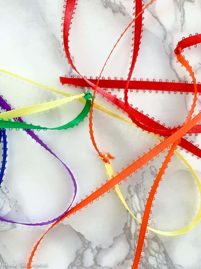 Tie the ribbon together to create one long ribbon used to create a DIY rainbow ribbon sculpture.