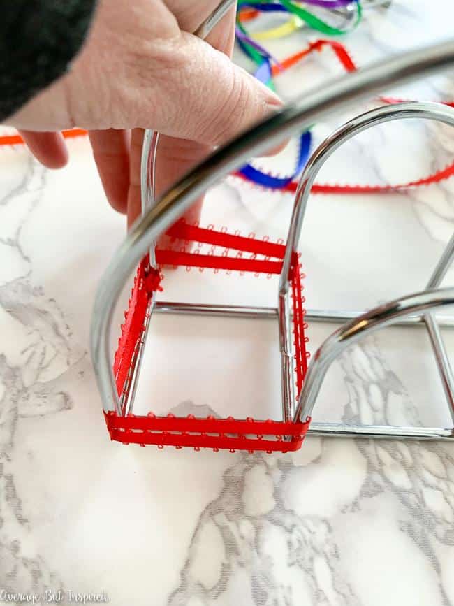 Keep wrapping ribbon around the metal napkin holder.