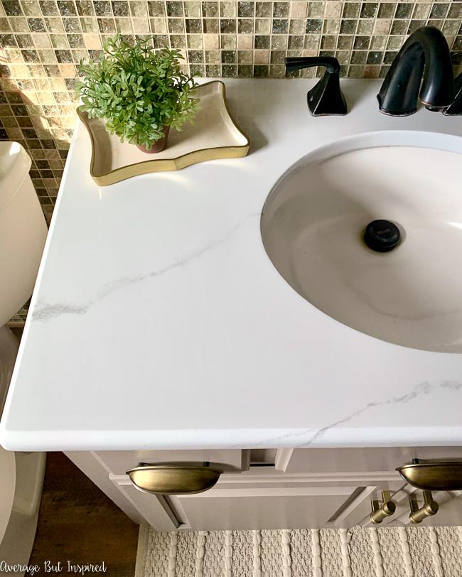 This is amazing! This blogger painted her bathroom countertop to look like marble! She how she painted her ugly granite countertop in this post!