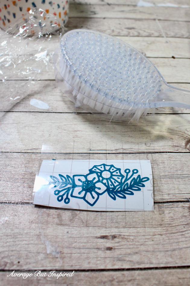 Cut Cricut Joy Smart Vinyl to embellish a dollar store bath brush as part of a bath spa gift set.