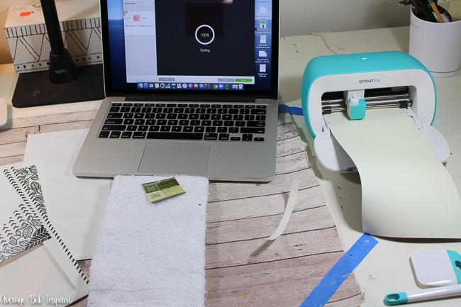 Cut Cricut Joy Smart Iron-On Vinyl to customize a dollar store hand towel.