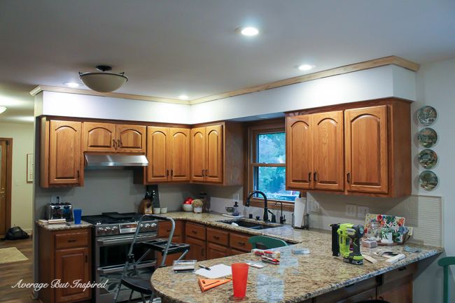 In the first part of disguising her kitchen soffit, this blogger added crown molding to the top of the soffit.