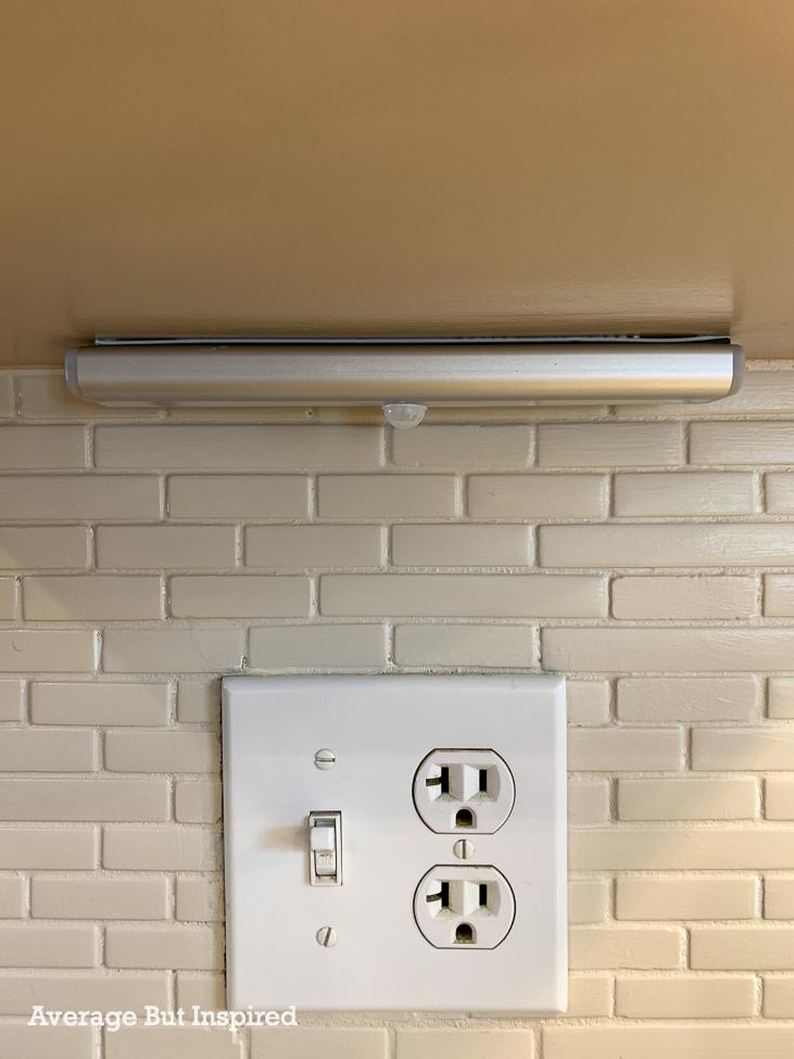 These under cabinet lights attach to the cabinet with self-adhesive magnetic strips. This makes them very easy to remove for charging.