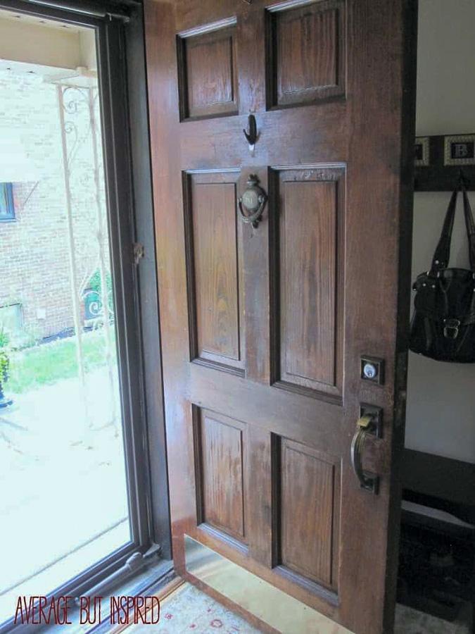 The BEFORE photo of this wood front door is sad. Learn how to restain a wood door with gel stain and make it look brand new.