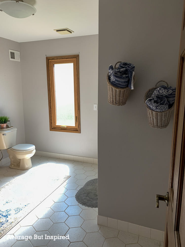 BEFORE - this bathroom has hexagon tile and oak trim. It's getting a modern vintage makeover.