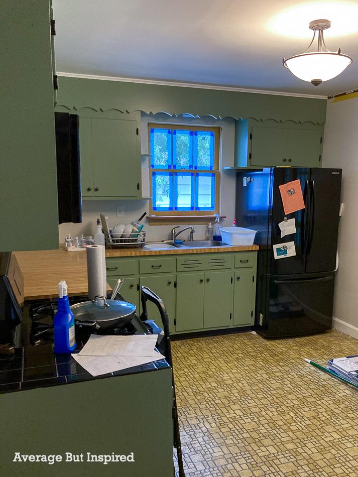 Before this kitchen had dated linoleum flooring. It has a new peel and stick kitchen floor with FloorPops.